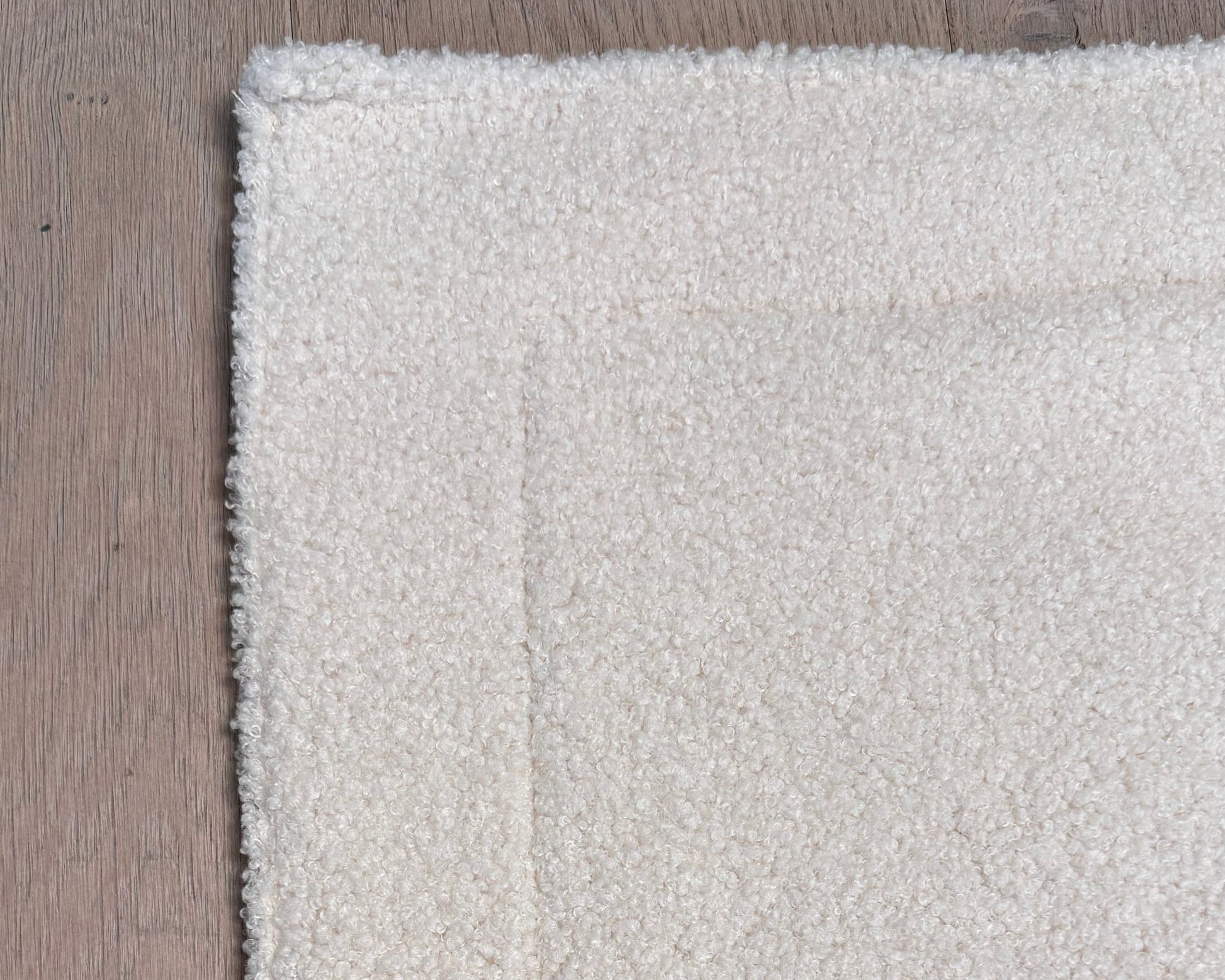 Nahaufnahme Bouclé-Stoff in Creme/Offwhite – Dozzy Cozy Reisedecke Bouclé ohne Füllung, waschbar bei 30 Grad
